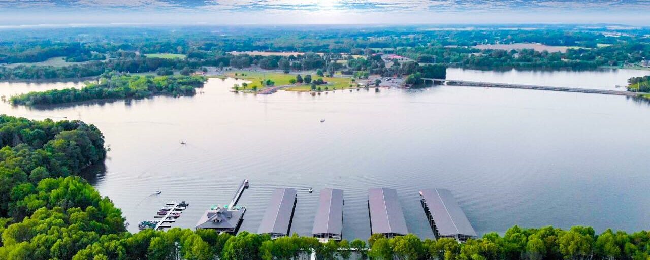 An aerial view showcasing a serene lake enveloped by lush trees in South Central Tennessee.